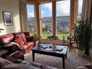 a living room with couches and a coffee table at Beinn Bhracaigh in Pitlochry