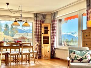 a dining room with a table and a large window at Sunny Alpine Apartment - 180 View in Lens