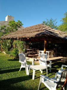 a group of chairs and a table in front of a pavilion at Cabañas Yunyay in Villa Cura Brochero