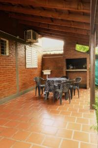 a group of tables and chairs on a patio at Cabañas Yunyay in Villa Cura Brochero