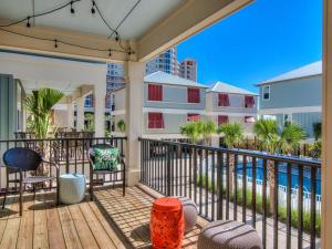 a balcony with chairs and a view of the water at PRIME Coral Dreams Walk to Beach Pool Pets Near The Hangout Parking in Gulf Shores