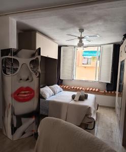 a bedroom with a bed with a woman wearing sunglasses at Casa Angeles in Castell de Ferro