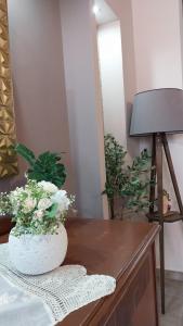 a table with a vase of flowers on top of it at Speranza's Sweet Home, Family House with Garden in Vrontantos in Vrontádos