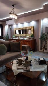 a living room with a couch and a table at Speranza's Sweet Home, Family House with Garden in Vrontantos in Vrontádos