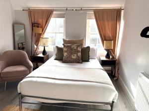 a bedroom with a bed and a chair and a window at Soho Room n4 in London +13 photos