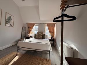 a bedroom with a white bed and a room with a window at Soho Room n4 in London