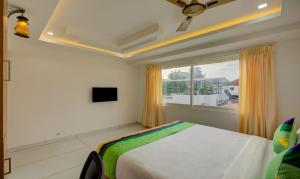 a bedroom with a bed and a window at casa Verde Kochi in Cochin +20 photos