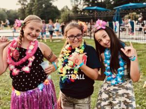 three girls are posing for a picture in a park at Jellystone Park Gardiner in Gardiner +143 photos