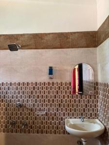 a bathroom with a sink and a mirror at Villa Mud Apple in Varkala +28 photos