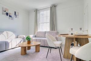 a living room with a couch and a table at 7 Clarendon Place in Maidstone