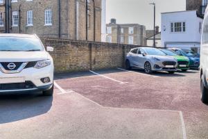 a group of cars parked in a parking lot at 7 Clarendon Place in Maidstone