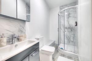 a white bathroom with a toilet and a shower at 7 Clarendon Place in Maidstone +33 photos