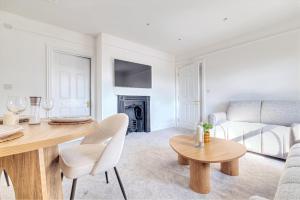 a living room with a table and a couch at 7 Clarendon Place in Maidstone