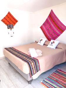 a bedroom with a bed with a canopy over it at Misky Wasi in San Pedro de Atacama