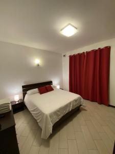 a bedroom with a bed with a red curtain at Borghaus Iseo in Iseo