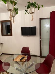 a living room with a table and chairs and a tv at Borghaus Iseo in Iseo
