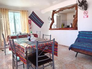 a dining room with a table and a mirror at Misky Wasi in San Pedro de Atacama