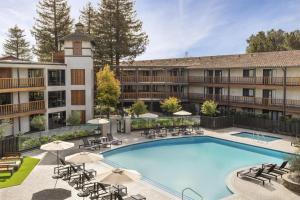 an image of a hotel with a large swimming pool at Casa Mani Resort Napa Valley, Curio Collection By Hilton in Napa