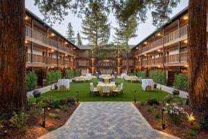 an image of the courtyard of a hotel with tables and chairs at Casa Mani Resort Napa Valley, Curio Collection By Hilton in Napa