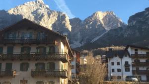 a group of buildings in front of a mountain at Casa Romeo in San Vito di Cadore