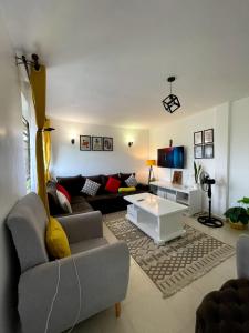a living room with a couch and a coffee table at Bay Loft 1 Br Netflix Lake Views, Starlink in Homa Bay