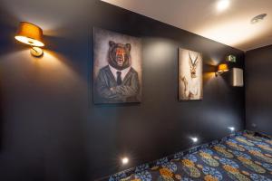 a room with three paintings of a bear on the wall at Początek Jutra in Pajewo +1 photo