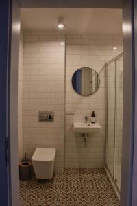 a bathroom with a toilet and a sink at Początek Jutra in Pajewo