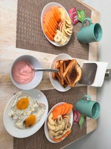 a table with four plates of breakfast food on it at Hotel Casa 22 in San Miguel de Allende +19 photos