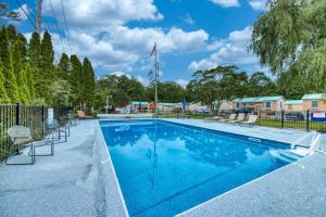 a large swimming pool with chairs around it at Shorelands Resort Cottage 40 in Kennebunk