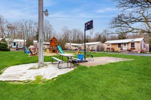 a park with a picnic table and a playground at Shorelands Resort Cottage 40 in Kennebunk