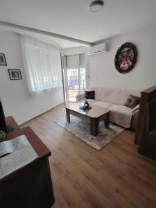 a living room with a couch and a coffee table at Silver Moon 1 in Veliko Gradište