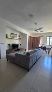 a living room with a couch and a table at Sugar Reef West Coast in Flic-en-Flac +35 photos