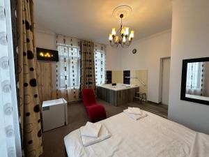 a hotel room with two beds and a bathroom at LuxInn in Bucharest