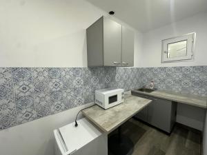 a small kitchen with a microwave on a counter at LuxInn in Bucharest