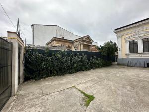 an empty parking lot in front of a fence at LuxInn in Bucharest