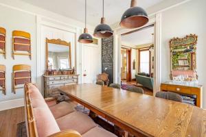 a dining room with a wooden table and chairs at Saint Helens House-Hotel Historic District Near Cruise Port in Galveston