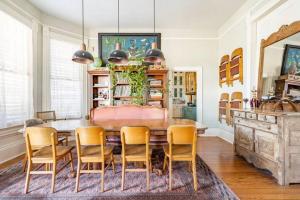 a dining room with a wooden table and chairs at Saint Helens House-Hotel Historic District Near Cruise Port in Galveston
