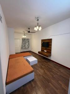 a large living room with a flat screen tv at Sunshine Park By RoomzAway in Candolim