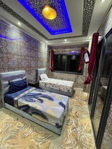 a bedroom with a bed and a blue ceiling at Villa isouktan in Sbiti +39 photos