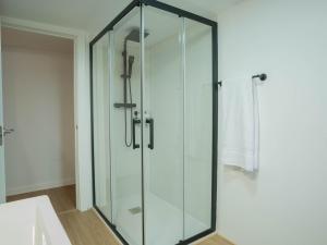 a glass shower stall in a bathroom at Refugio 1900 in San Cristóbal de Segovia