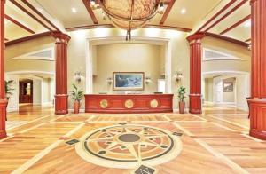 an empty lobby with a large room with wood columns at Breathtaking Views Emerald Grande 3BR,2BA 904E in Destin +87 photos