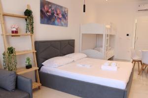 a small bedroom with a bed and a chair at Aura boutique hotel in Vlorë