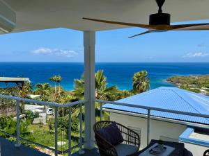 a balcony with a view of the ocean at Espace Harmonie - Gîte Indigo Deshaies in Deshaies