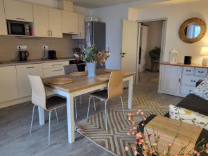 a kitchen and living room with a table and chairs at Chalet Pasečná Apartments in Přední Výtoň