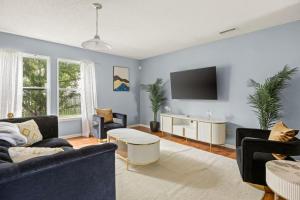a living room with a couch and a tv at Quiet Avon Retreat in Indianapolis