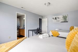 a bedroom with a large white bed and a desk at Quiet Avon Retreat in Indianapolis