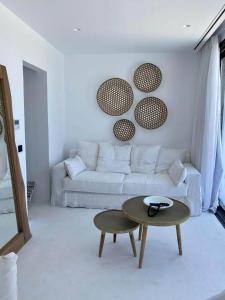 a living room with a white couch and a table at The Cove Sivota Bay in Sivota +28 photos