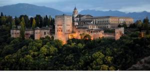 a large castle on top of a hill with trees at Casa Angeles in Castell de Ferro