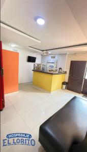 an empty room with a counter in a building at Hospedaje El Lorito in Barranquilla