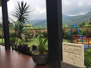 a room with a view of a garden with a playground at Avilla Puncak in Puncak